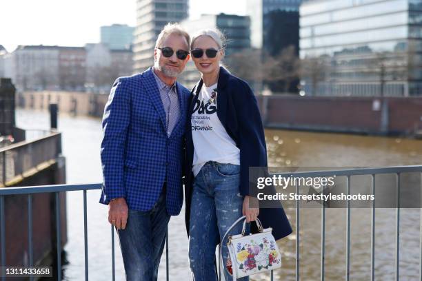 Best Ager Model and Influencer Petra van Bremen wearing sunglasses by Dior, a dark blue coat by Juvia, a white t-shirt with black logo print by Dolce...