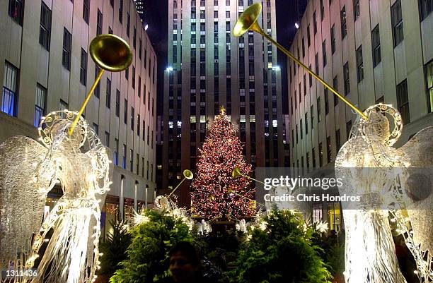 The Rockefeller Center plaza, with lit statues of angels and the famous Christmas tree, is ablaze with lights December 10, 2000 in New York. In...