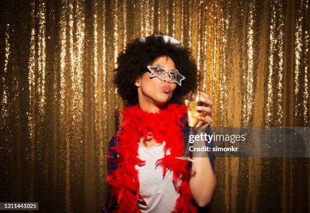portrait of young woman enjoying party - feather boa stock pictures, royalty-free photos & images