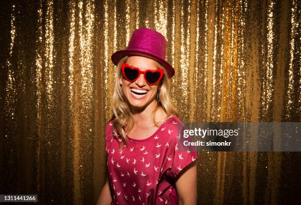 portrait of smiling woman enjoying party - party prop stock pictures, royalty-free photos & images