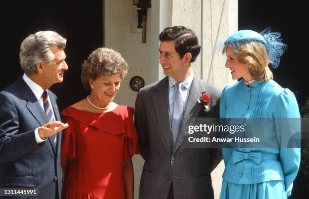 Prince Charles, Prince of Wales and Diana, Princess of Wales , wearing a two piece turquiose silk suit with a pintucked bodice and madarin collar...