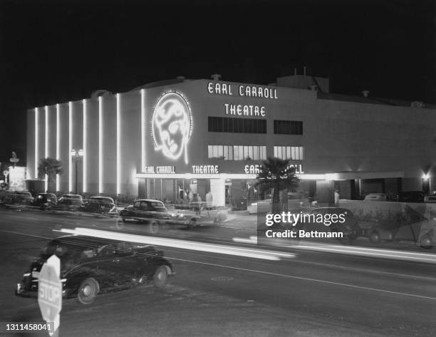 The Earl Carroll Theatre, its signage illuminated as night falls on Sunset Boulevard in Los Angeles, California, 13th September 1939. Designed by...