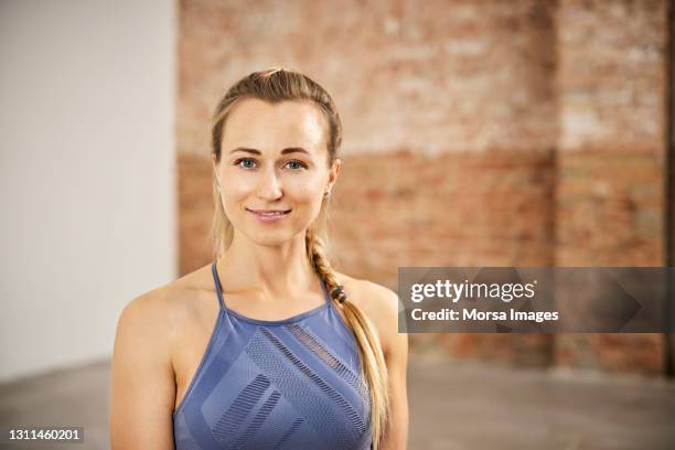 beautiful blond smiling female yoga instructor - yoga instructor stock pictures, royalty-free photos & images