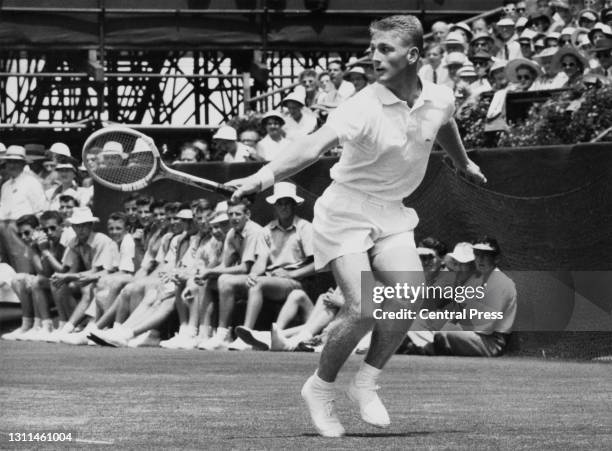 Lew Hoad of Australia follows his backhand return against Tony Trabert of the United States during their Men's Singles match of the 43rd edition of...