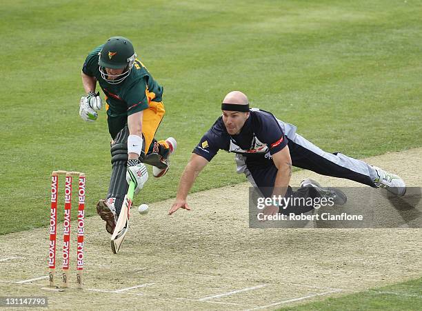 Jayde Herrick of the Bushrangers dives in an attempt to dismiss George Bailey of the Tigers during the Ryobi One Day Cup match between the Tasmania...