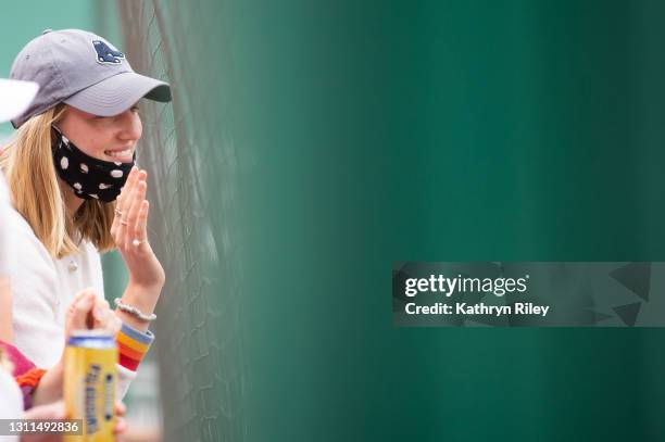 Fan waves to a player during the game between the Tampa Bay Rays and the Boston Red Sox at Fenway Park on April 7, 2021 in Boston, Massachusetts.