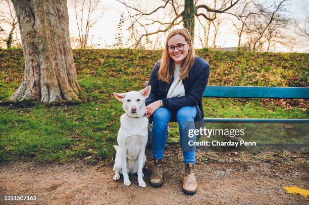 the park really is our favourite place - woman dog bench stock pictures, royalty-free photos & images