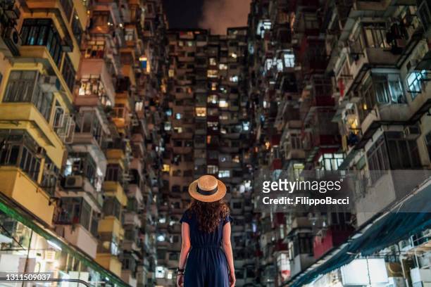 young adult woman exploring quarry bay district in hong kong - white hat fashion item stock pictures, royalty-free photos & images