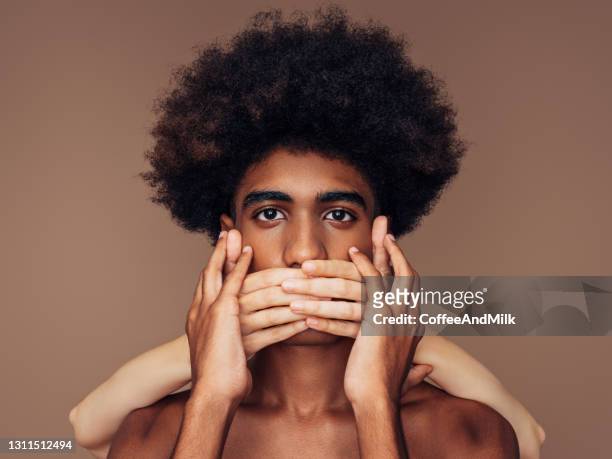 closing his mouth - woman hush stock pictures, royalty-free photos & images