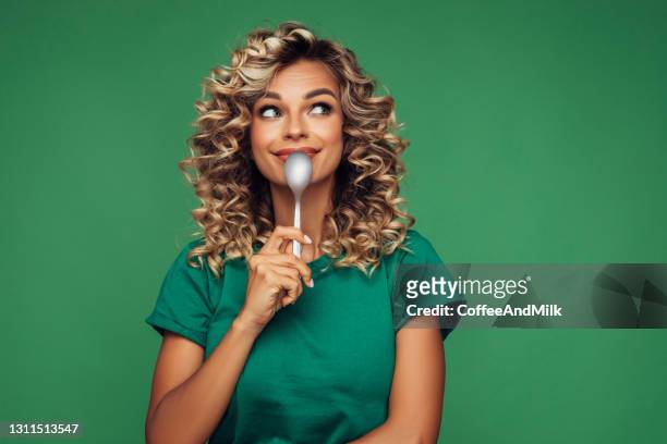 lovely girl holding a spoon - woman mouth stock pictures, royalty-free photos & images