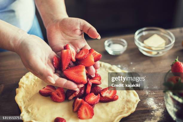 young woman preparing strawberry galette or open strawberry pie - strawberry tart stock pictures, royalty-free photos & images