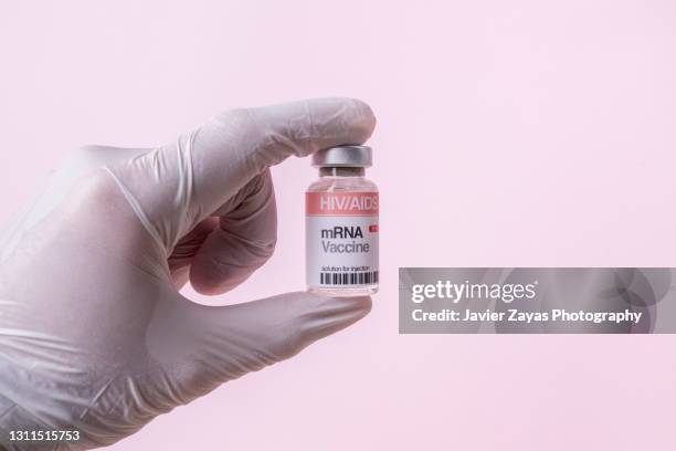 mrna vaccine vial for hiv/aids on pink background - aids stock pictures, royalty-free photos & images