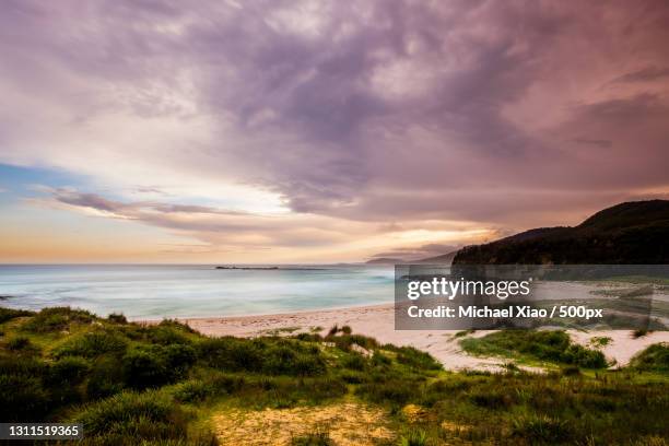 scenic view of beach against sky during sunset,murramarang national park,new south wales,australia - nsw stock pictures, royalty-free photos & images