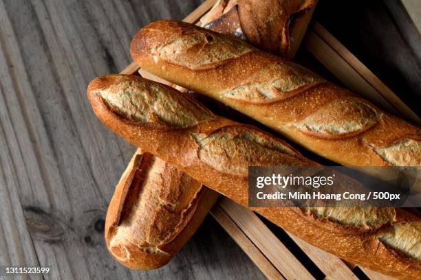 high angle view of breads on table,france - barra de pan francés fotografías e imágenes de stock