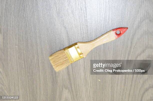 directly above shot of paintbrush on wooden table - oleg prokopenko stock pictures, royalty-free photos & images