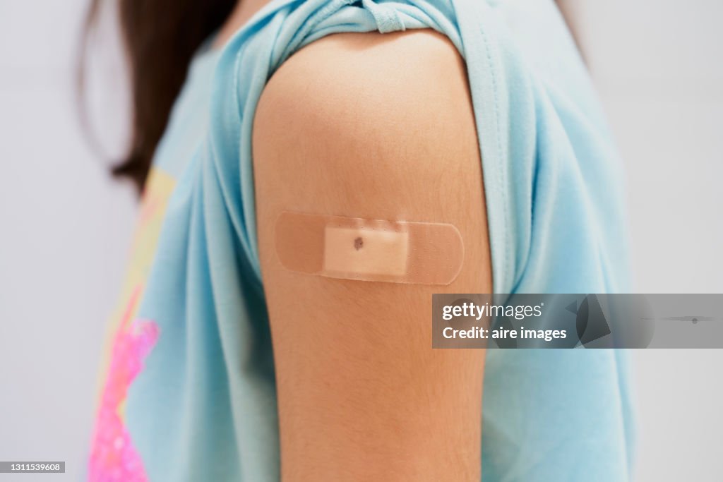 Girl proud to have received vaccine in arm