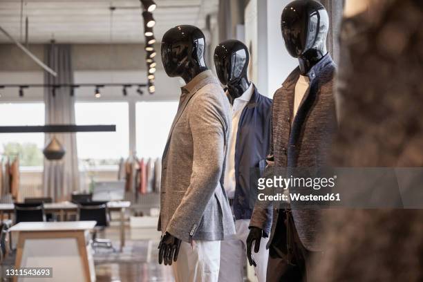 mannequins wearing business casuals at clothing design studio - menswear stock-fotos und bilder