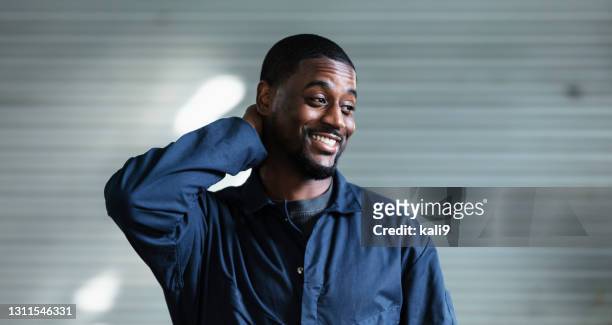 african-american auto mechanic in repair shop - scratching head stock pictures, royalty-free photos & images