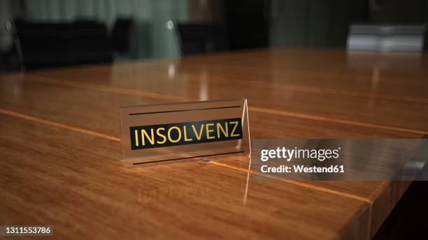 insolvency sign on conference table in office - conference table stock illustrations