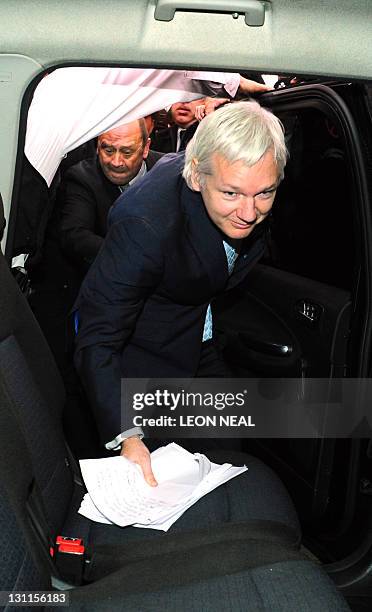 WikiLeaks founder Julian Assange climbs into a car upon leaving London's High Court on November 2, 2011 after losing his legal battle to avoid...