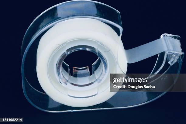 clear office tape on a black background - tape dispenser stock pictures, royalty-free photos & images
