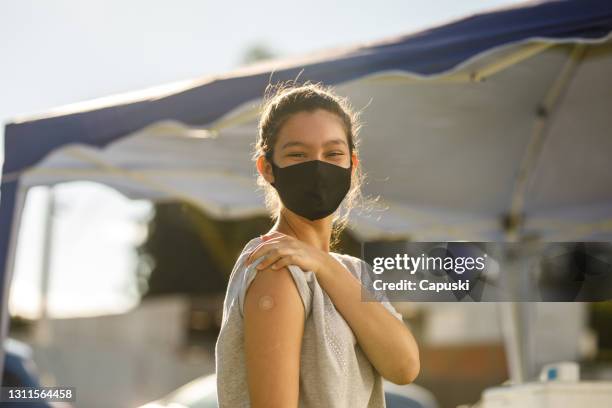 teen girl after her vaccination - covid 19 vaccine stock pictures, royalty-free photos & images