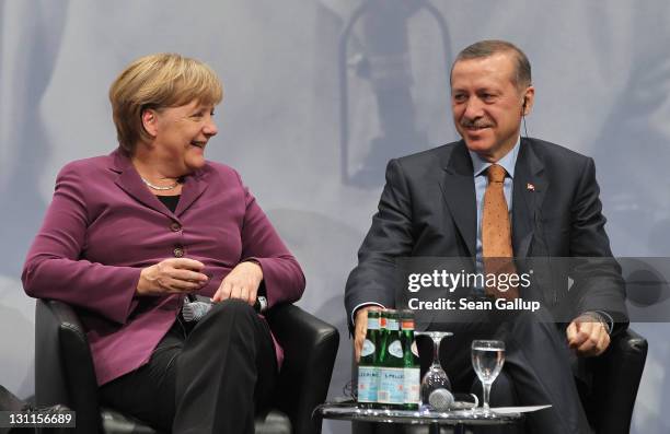 German Chancellor Angela Merkel and Turkish Prime Minister Recep Tayyip Erdogan attend a panel discussion at a celebration to mark 50 years of...