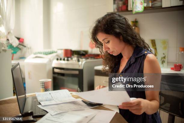 woman doing financial accounts at home. difficult financial situation. - tough decisions stock pictures, royalty-free photos & images