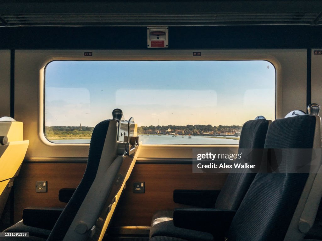 Modern passenger train interior with scenic window view