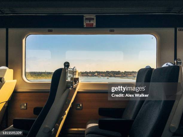 modern passenger train interior with scenic window view - railways uk stock-fotos und bilder