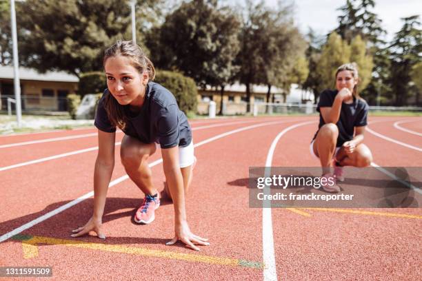 athlete on the running track ready for the start - womens track stock pictures, royalty-free photos & images
