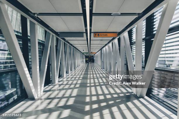 modern airport walkway - heathrow airport stock-fotos und bilder