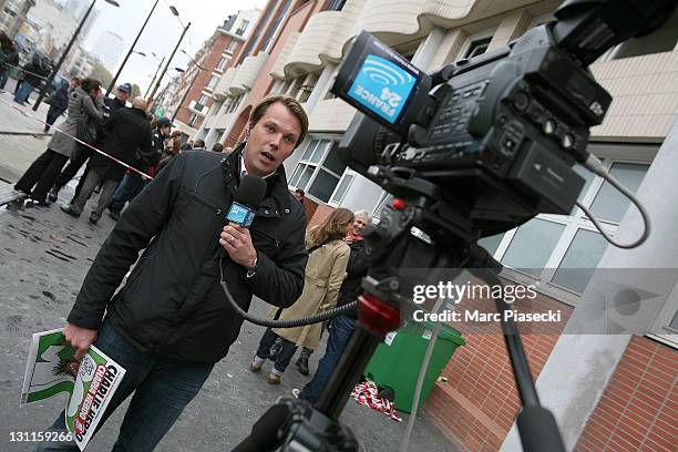 Journalist works outside the offices of French satirical magazine'Charlie Hebdo' following a petrol bomb attack on November 2, 2011 in Paris, France....