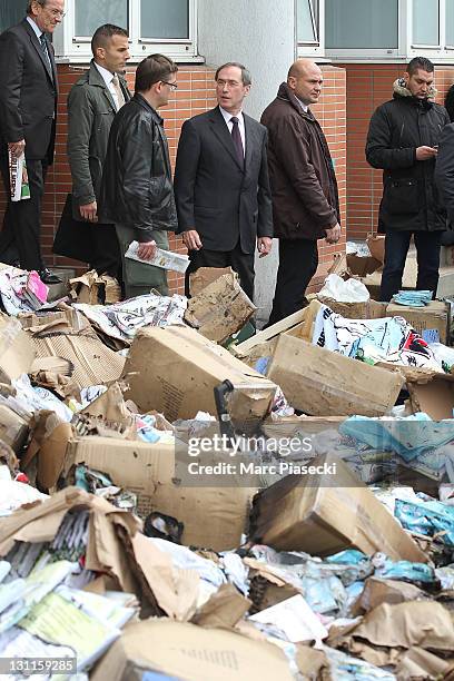 French minister of interior affairs Claude Gueant leaves the offices French satirical magazine 'Charlie Hebdo' following a petrol bomb attack on...