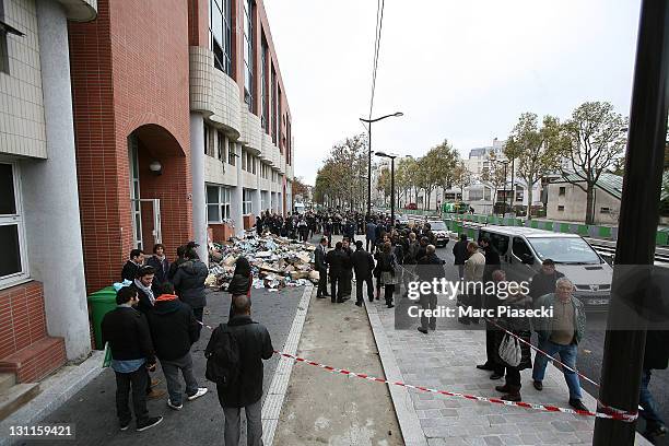 Police and media gather outside of the offices French satirical magazine 'Charlie Hebdo' following a petrol bomb attack on November 2, 2011 in Paris,...