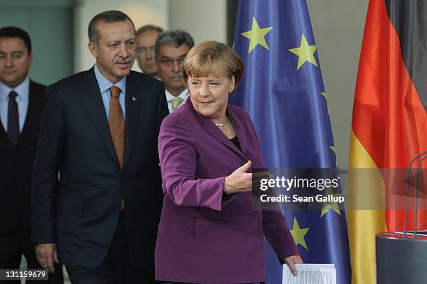 German Chancellor Angela Merkel and Turkish Prime Minister Recep Tayyip Erdogan arrive to speak to the media after talks at the Chancellery on...