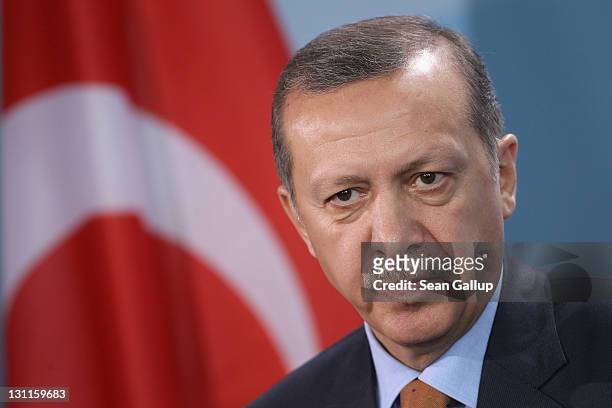 Turkish Prime Minister Recep Tayyip Erdogan speaks to the media following talks with German Chancellor Angela Merkel at the Chancellery on November...