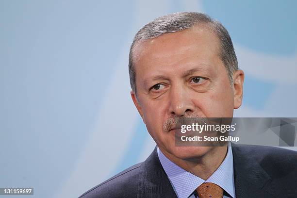 Turkish Prime Minister Recep Tayyip Erdogan speaks to the media following talks with German Chancellor Angela Merkel at the Chancellery on November...