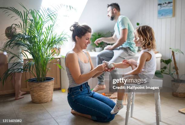 family with small children in bathroom at home, preparing for a bath. - brothers bathroom stock-fotos und bilder