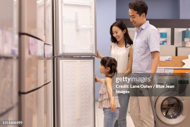 happy young family shopping in supermarket - mom fridge stock pictures, royalty-free photos & images