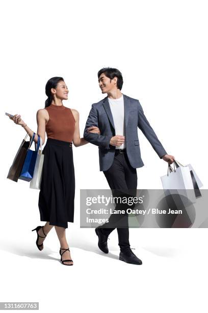 cheerful couple shopping together - couple walking shopping stock-fotos und bilder