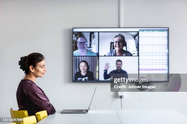 woman in boardroom having video conference - laptop side view stock pictures, royalty-free photos & images