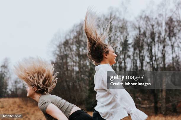 happy female friends - dancing in the rain stock pictures, royalty-free photos & images