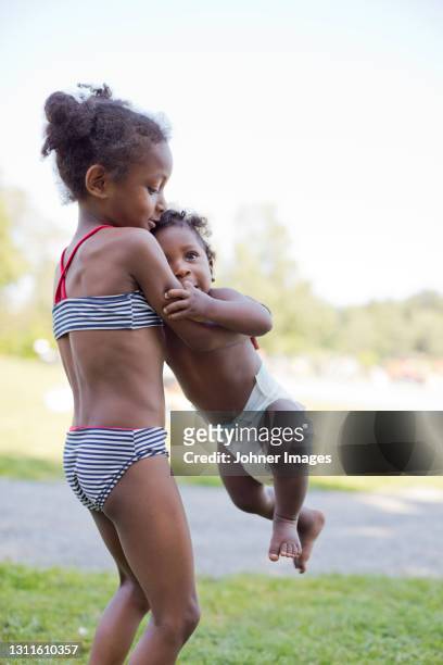 girl playing with baby brother - diaper teen stock pictures, royalty-free photos & images