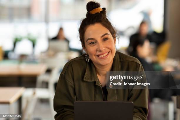 smiling woman in cafe looking at camera - woman with long hair stock pictures, royalty-free photos & images