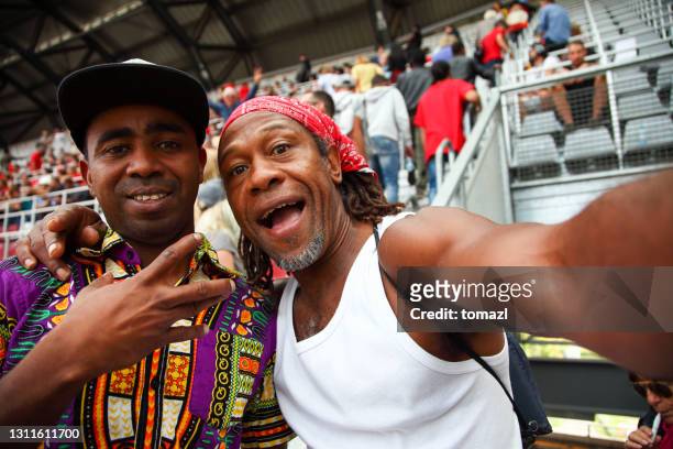 afro-american friends portrait at a sport event - fan concert stock pictures, royalty-free photos & images