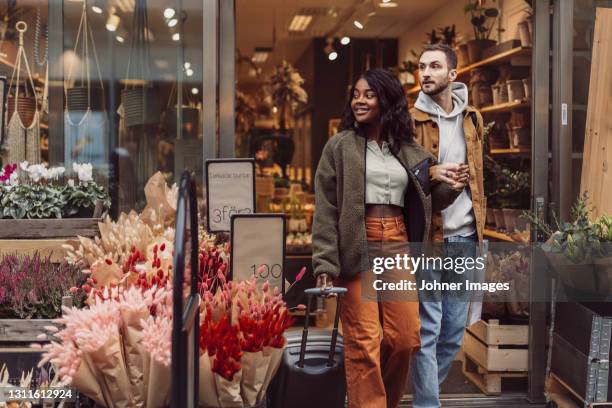 couple leaving shop - young couple shopping stock pictures, royalty-free photos & images