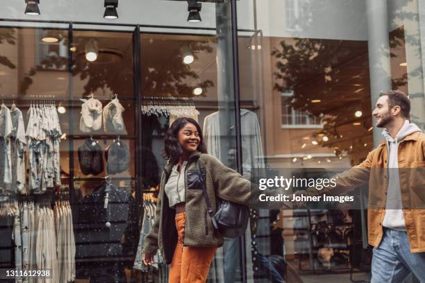 happy couple walking together - real people shopping stock pictures, royalty-free photos & images