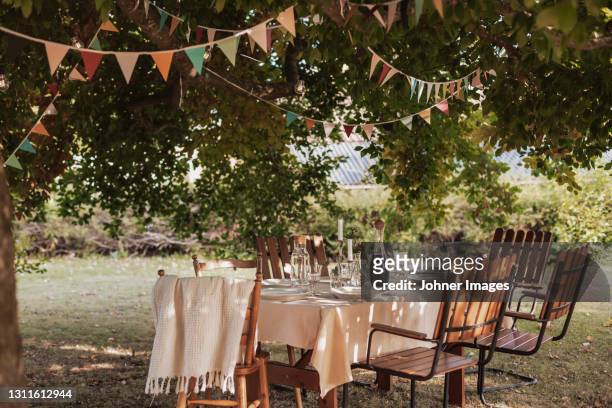table in garden set for meal - garden party stock pictures, royalty-free photos & images