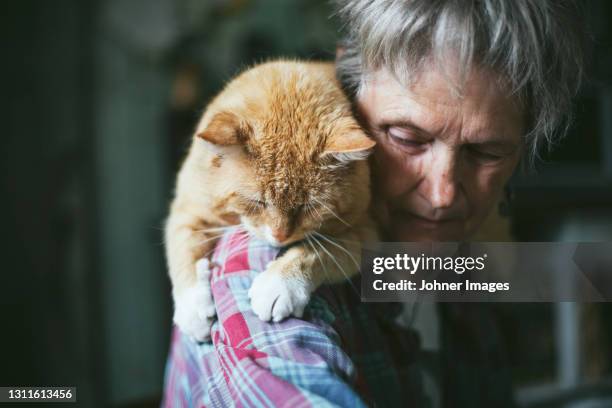 senior woman with car on shoulders - old lady cat stock pictures, royalty-free photos & images